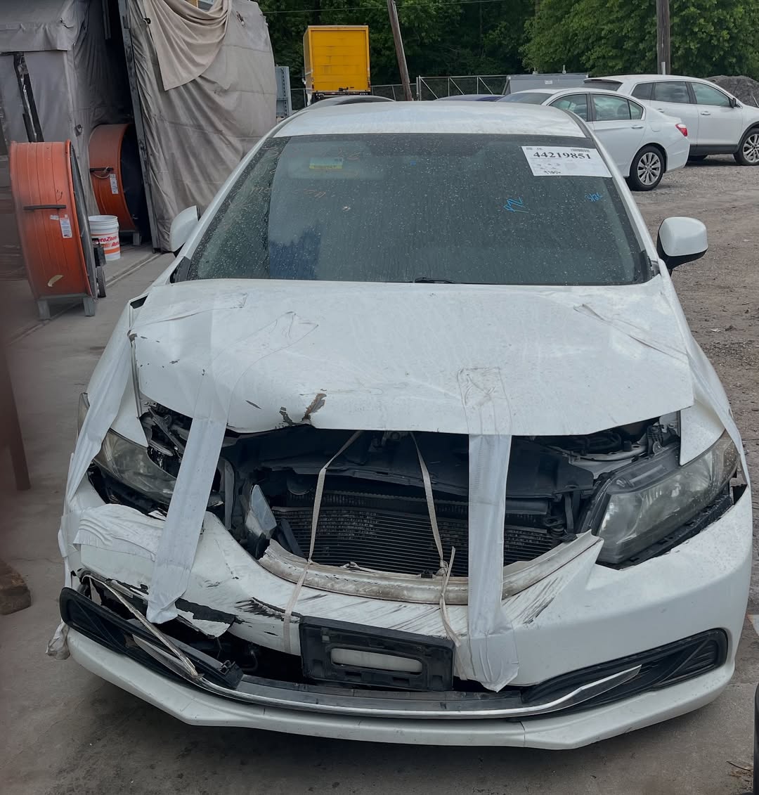 Honda Civic before repair — front end destroyed, hood and bumper demolished