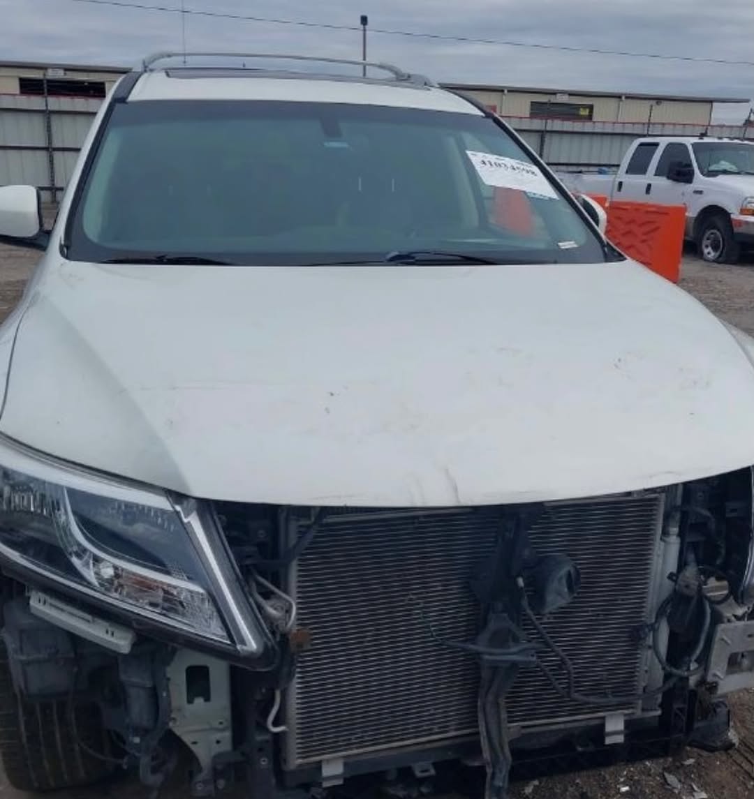 Nissan Pathfinder in teardown — front bumper and components removed for repair